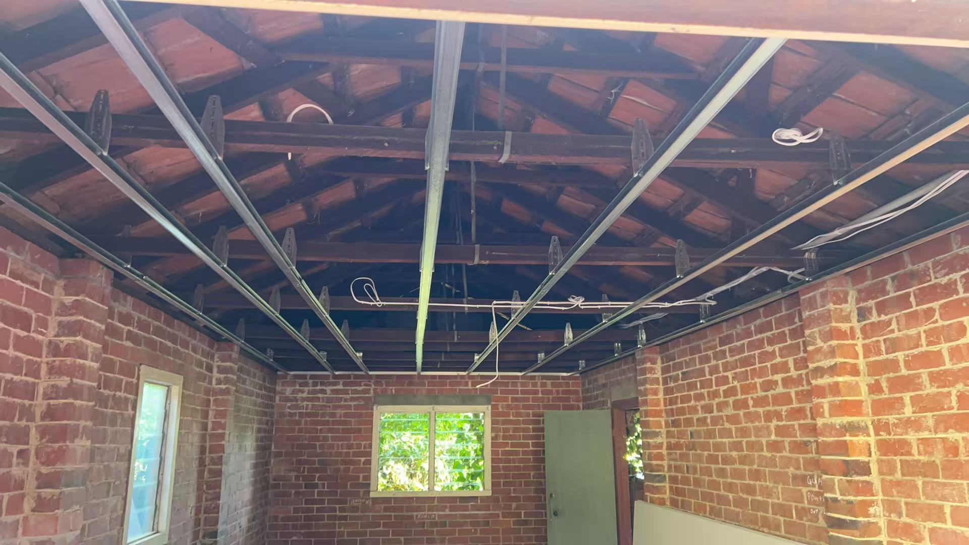 Large open-plan room with timber ceiling framing